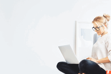 Woman on laptop researching ways to build her generational wealth